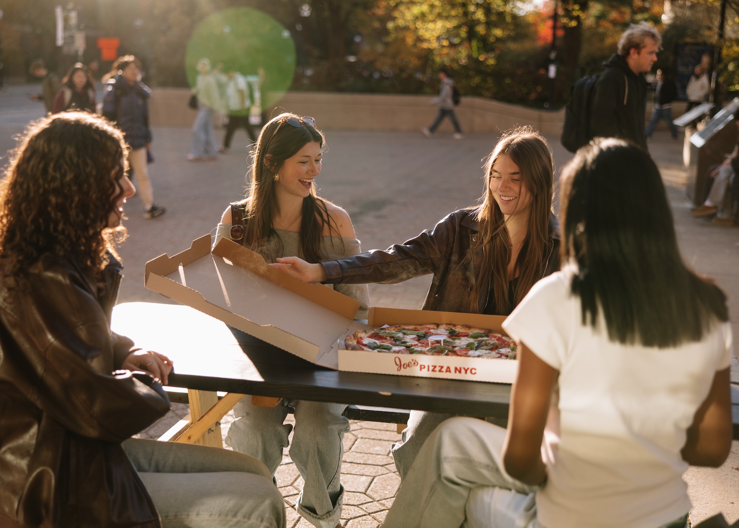 University of Michigan students and Rambler Ann Arbor residents eating Joe's Pizza